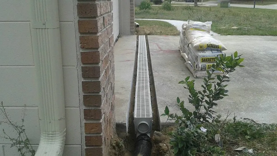 Channel drain end outlet corrugated pipe brick wall downspout, Sanford